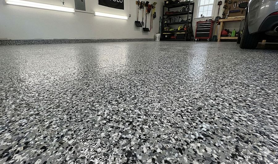 Speckled epoxy garage floor coating with storage shelves in Castle Rock, CO